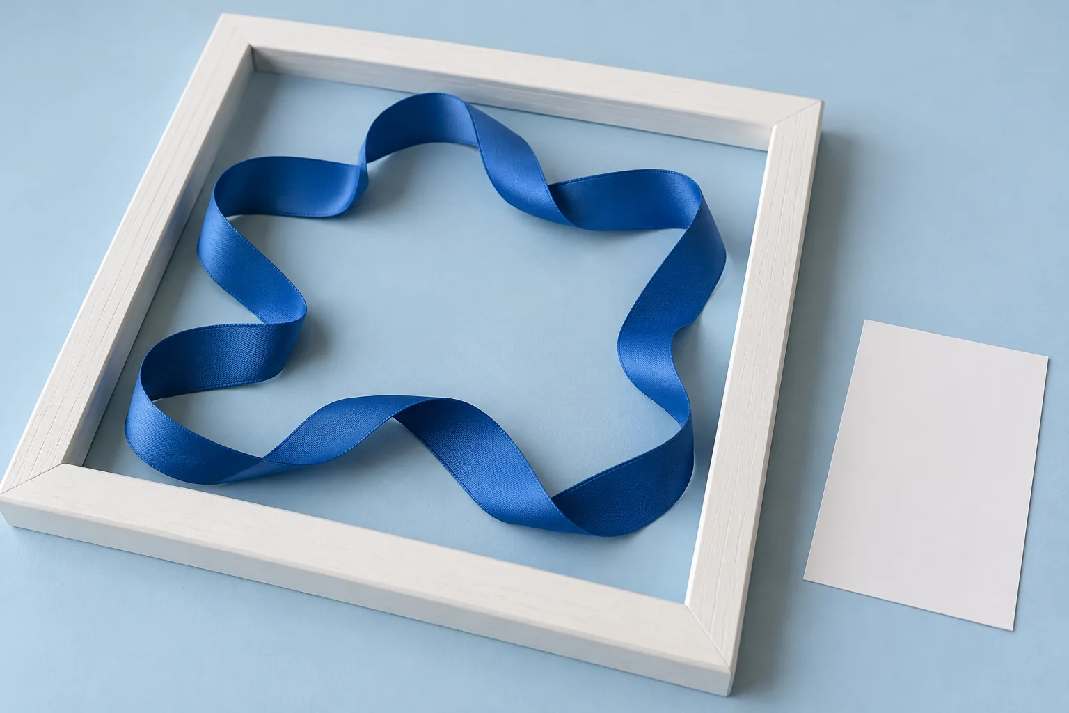 Ein gefaltetes blaues Band liegt vollständig innerhalb eines weißen quadratischen Rahmens